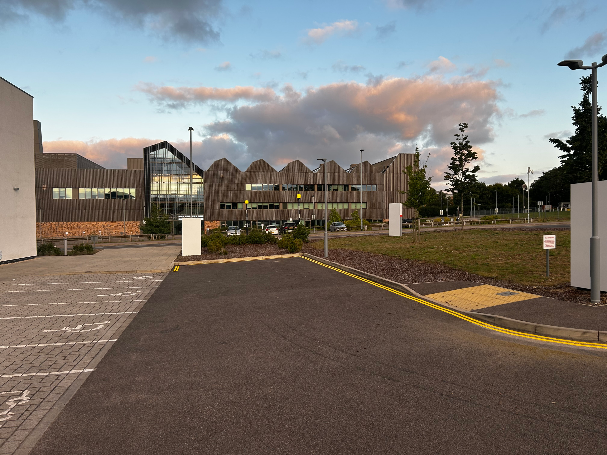 Accessible Parking Spaces Modern building with parking lot and yellow road line painting.