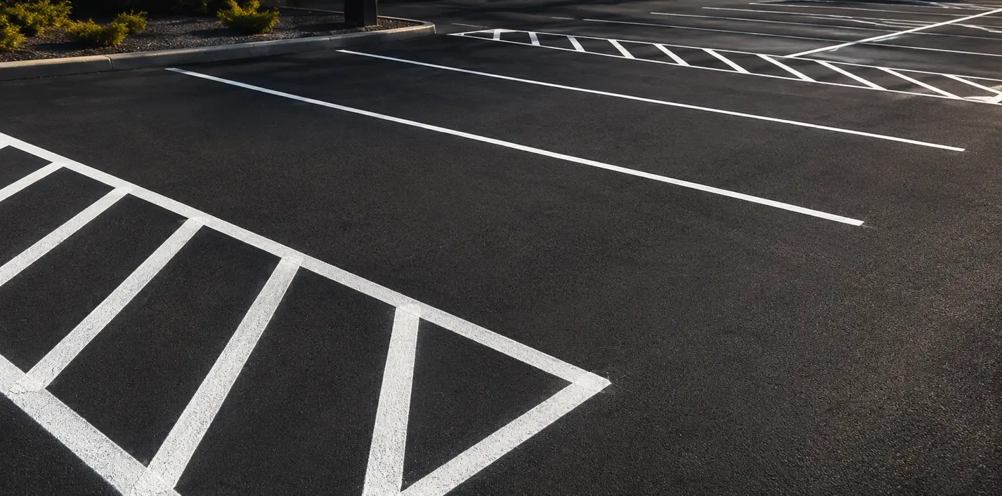 Fresh white car park bay lines at a commercial premises in Ipswich