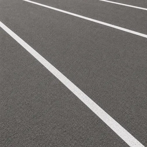Close-up of fresh white line markings on commercial tarmac in Norfolk